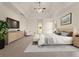 Stylishly furnished main bedroom with trey ceiling, ceiling fan, carpeted floors, and a large bed at 6050 Providence Ln, Cumming, GA 30040