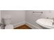 Elegant powder room featuring hardwood floors, decorative sink and a toilet at 6050 Providence Ln, Cumming, GA 30040