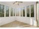 Cozy sunroom surrounded by large windows offering great natural light and wooded views at 6050 Providence Ln, Cumming, GA 30040