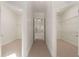 Hallway to two walk-in closets with ample shelving, ensuring plenty of storage space at 6050 Providence Ln, Cumming, GA 30040