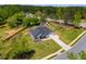 An aerial view of the house with a well-maintained lawn, landscaping, and a long driveway at 7001 Palomino Trl, Winston, GA 30187