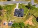 An aerial view showing the home's landscaping and the partially fenced backyard with a shed and gazebo at 7001 Palomino Trl, Winston, GA 30187