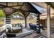 Inviting back patio area with a hot tub, comfortable seating, and shade at 7001 Palomino Trl, Winston, GA 30187