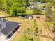 An aerial view showcasing a fenced backyard with garden beds, a shed, and a gazebo at 7001 Palomino Trl, Winston, GA 30187