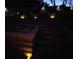 Backyard featuring tiered retaining wall and landscape lighting at night at 7001 Palomino Trl, Winston, GA 30187