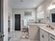 Bright bathroom featuring a soaking tub, grey tile backsplash, and vanity with sink, adjacent to toilet room at 7001 Palomino Trl, Winston, GA 30187