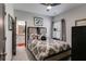 This cozy bedroom is painted gray and has carpet, a queen bed, and a gray and black door at 7001 Palomino Trl, Winston, GA 30187