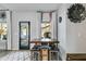 Cozy breakfast nook with seating and storage beneath a modern wood table with black accents near a patio door at 7001 Palomino Trl, Winston, GA 30187