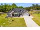 Charming single Gathering home boasts a long driveway and well-manicured lawn at 7001 Palomino Trl, Winston, GA 30187