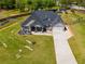 Aerial shot featuring a house with a two-car garage, a long driveway, and lush landscaping at 7001 Palomino Trl, Winston, GA 30187