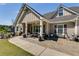 Inviting front porch with seating, potted plants, and stone-paved walkway at 7001 Palomino Trl, Winston, GA 30187