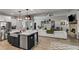 Open floor plan featuring a modern kitchen with island and stainless steel appliances flows into a living room with fireplace at 7001 Palomino Trl, Winston, GA 30187