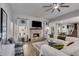 Cozy living room features a ceiling fan and stone fireplace with mounted TV at 7001 Palomino Trl, Winston, GA 30187