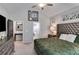 Main bedroom featuring a tufted headboard, sitting chair, and an ensuite bathroom with a vanity at 7001 Palomino Trl, Winston, GA 30187