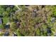 An aerial view shows the wooded surroundings and nearby streets of the property at 11815 Mountain Laurel Dr, Roswell, GA 30075