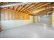 Unfinished basement with exposed beams and unfinished walls, ready for customization at 11815 Mountain Laurel Dr, Roswell, GA 30075