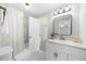 Bright bathroom featuring a vanity with a mirror, toilet, and shower at 11815 Mountain Laurel Dr, Roswell, GA 30075
