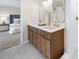 Bathroom vanity with double sinks, quartz countertops, and wooden cabinets at 11815 Mountain Laurel Dr, Roswell, GA 30075