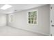 Bedroom featuring carpet, two windows for natural light, and a neutral color scheme at 11815 Mountain Laurel Dr, Roswell, GA 30075