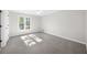Empty bedroom with a large window and neutral carpet, perfect for personalization at 11815 Mountain Laurel Dr, Roswell, GA 30075