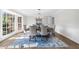 Formal dining room featuring a modern chandelier, light gray walls, and large windows at 11815 Mountain Laurel Dr, Roswell, GA 30075