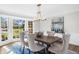 Elegant dining room with hardwood floors, a large bay window, and stylish furnishings at 11815 Mountain Laurel Dr, Roswell, GA 30075