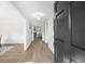 Inviting foyer with wood floors, white wainscoting, and a view into the living area at 11815 Mountain Laurel Dr, Roswell, GA 30075