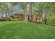 Charming single-story brick home with a well-manicured lawn and mature trees providing shade at 11815 Mountain Laurel Dr, Roswell, GA 30075