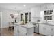 Bright kitchen with an island, stainless steel appliances, and white cabinets at 11815 Mountain Laurel Dr, Roswell, GA 30075