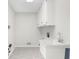 Bright laundry room with utility sink and tile flooring at 11815 Mountain Laurel Dr, Roswell, GA 30075