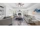 Bright living room features a fireplace, ceiling fan, built-in shelving, and stylish decor at 11815 Mountain Laurel Dr, Roswell, GA 30075