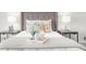 Close up of main bedroom with tray on the bed with pillows and lamps on each side at 11815 Mountain Laurel Dr, Roswell, GA 30075