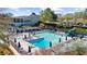 An aerial view of the pool with lounge chairs, umbrellas, and a pool house at the Country Club at 11815 Mountain Laurel Dr, Roswell, GA 30075