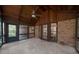 Enclosed sunroom featuring brick walls, ceiling fan, and tiled floors at 11815 Mountain Laurel Dr, Roswell, GA 30075