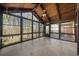Light-filled sunroom featuring a vaulted wood ceiling, large windows, and tile floors at 11815 Mountain Laurel Dr, Roswell, GA 30075