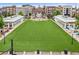 Aerial view of a green space surrounded by multi-story buildings with restaurants and shops at 3988 Dover Ave, Alpharetta, GA 30009