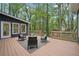 Cozy back deck with outdoor seating, perfect for relaxing and enjoying the peaceful, wooded views at 3988 Dover Ave, Alpharetta, GA 30009