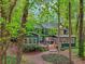 Charming home featuring a spacious deck and lush landscaping at 3988 Dover Ave, Alpharetta, GA 30009
