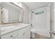 Light and airy bathroom featuring a vanity with modern fixtures, tiled shower and floors at 3988 Dover Ave, Alpharetta, GA 30009