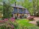 Charming two-story home with a stone accents, a two-car garage, and mature landscaping at 3988 Dover Ave, Alpharetta, GA 30009