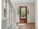Welcoming foyer with hardwood floors and an ornate glass-paneled front door, bathed in natural light at 3988 Dover Ave, Alpharetta, GA 30009
