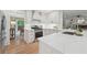 Bright kitchen featuring white cabinets, a gas range, and quartz countertops at 3988 Dover Ave, Alpharetta, GA 30009