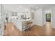Kitchen featuring a large island, stainless steel appliances, and white cabinets at 3988 Dover Ave, Alpharetta, GA 30009