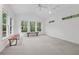 Bright, airy living room featuring a ceiling fan, multiple windows, and natural light at 3988 Dover Ave, Alpharetta, GA 30009