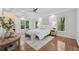 Bright main bedroom featuring hardwood floors, a fireplace, a ceiling fan, and ample natural light at 3988 Dover Ave, Alpharetta, GA 30009