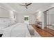 Bright main bedroom suite boasts hardwood floors, a ceiling fan, and a lovely ensuite bath at 3988 Dover Ave, Alpharetta, GA 30009