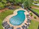 Aerial view of an in-ground kidney-shaped pool, covered, with a playground nearby and seating areas at 3988 Dover Ave, Alpharetta, GA 30009
