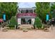 The Cape Restaurant & Beach Bar entrance is framed by flowers and lush greenery at 3988 Dover Ave, Alpharetta, GA 30009