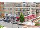 Street view of a brick building with shops and restaurants, some with balconies and outdoor seating at 3988 Dover Ave, Alpharetta, GA 30009