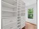 A well-organized walk-in closet provides ample storage with custom shelving and built-in drawers at 3988 Dover Ave, Alpharetta, GA 30009